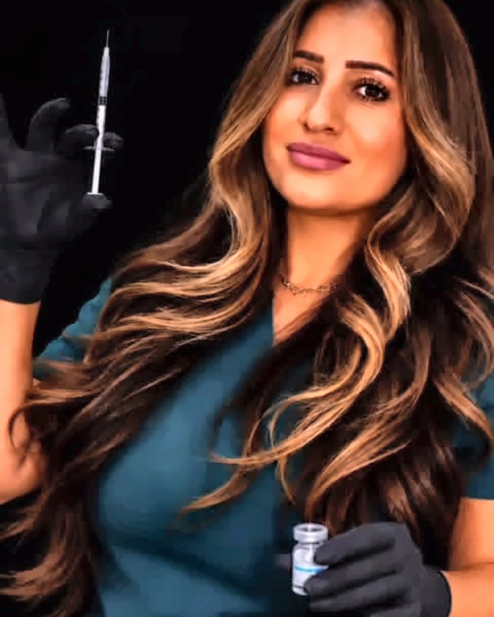 Phoebe, the specialist at Glow by Phoebe Med Spa, holding a prepared syringe and vial